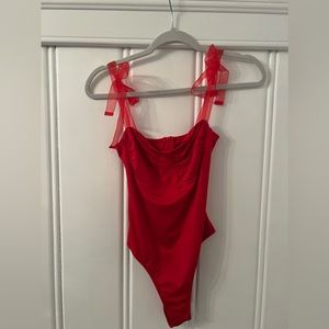 Red tie sleeve bodysuit.